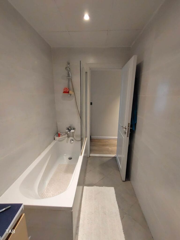 Bathroom wall tiling with gray marble effect tiles