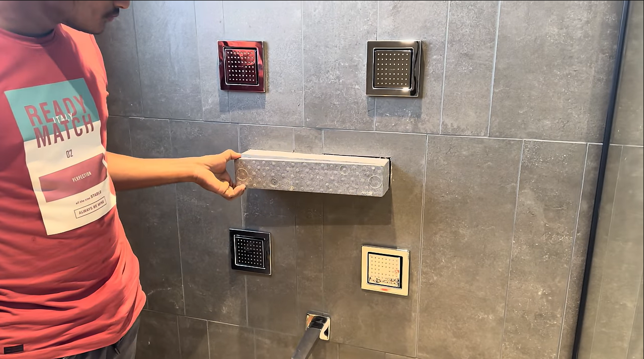 Professional plumber fixing a leaking pipe in a modern Dubai apartment kitchen with plumbing tools and equipment.