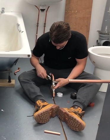 Professional plumber working on residential plumbing system in Dubai