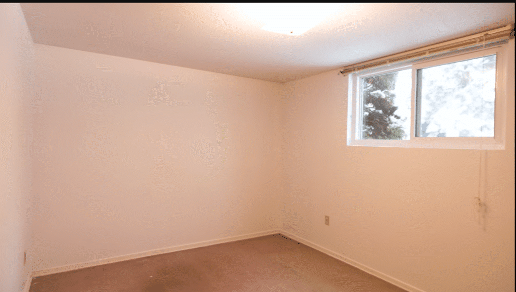 Bright and clean living room with freshly painted white walls.
