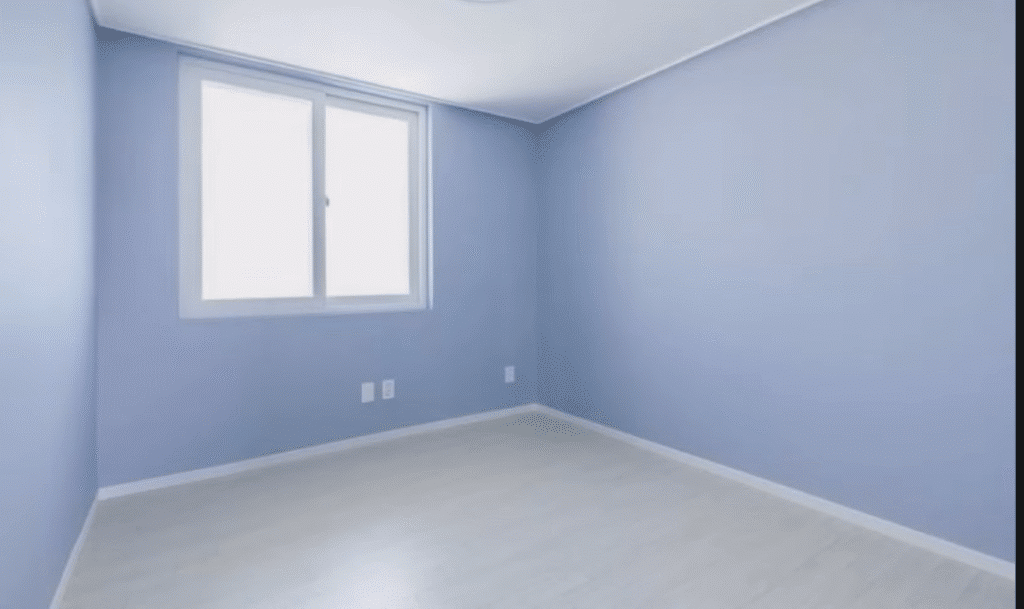 Finished bedroom with soft blue painted walls.