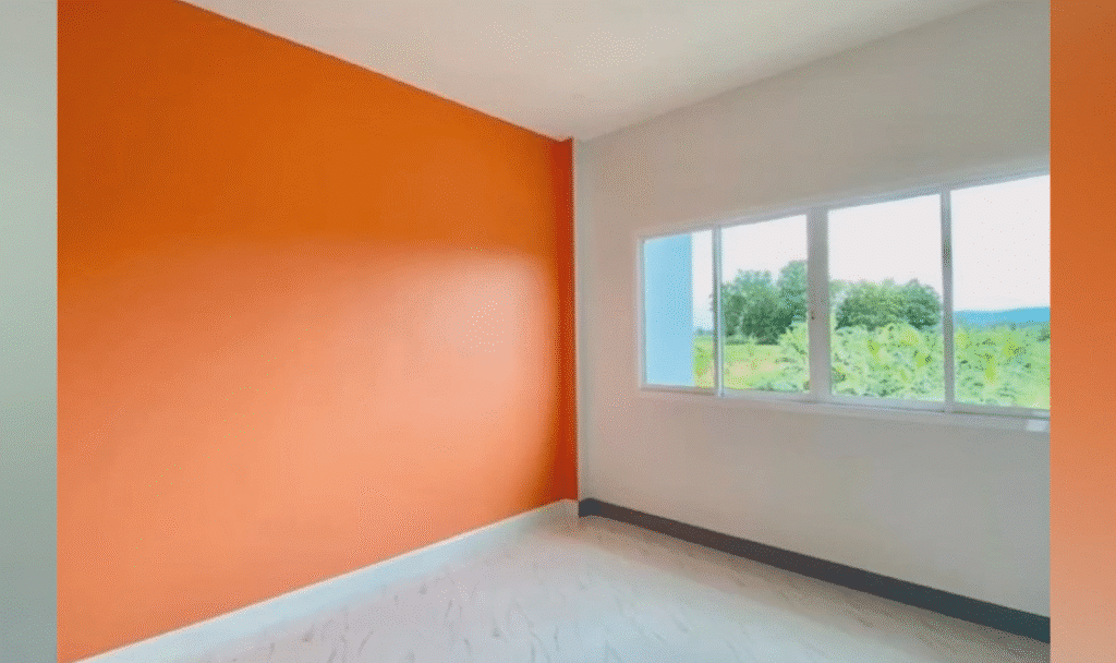 Freshly painted interior room with warm orange walls.