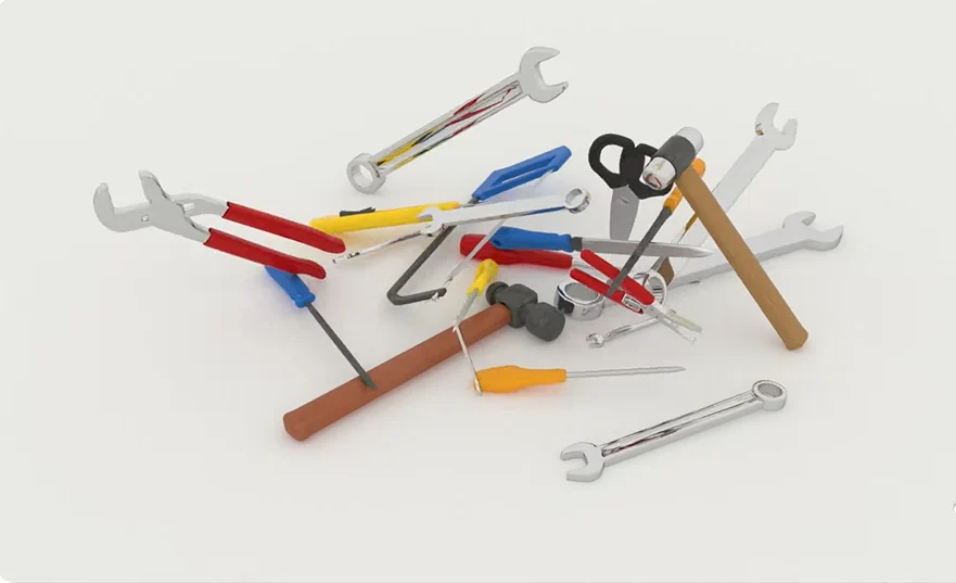 Set of electrician tools including pliers, screwdrivers, and voltage tester on a workbench