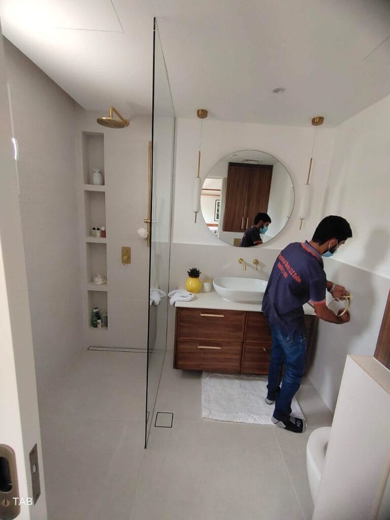 Full washroom renovation with new tiles, plumbing, and lighting